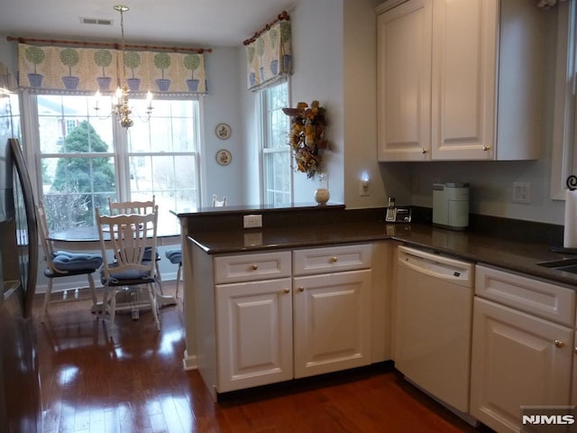 kitchen featuring kitchen peninsula, hanging light fixtures, dark hardwood / wood-style flooring, white dishwasher, and white cabinetry