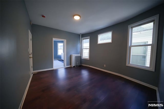 spare room with dark hardwood / wood-style floors