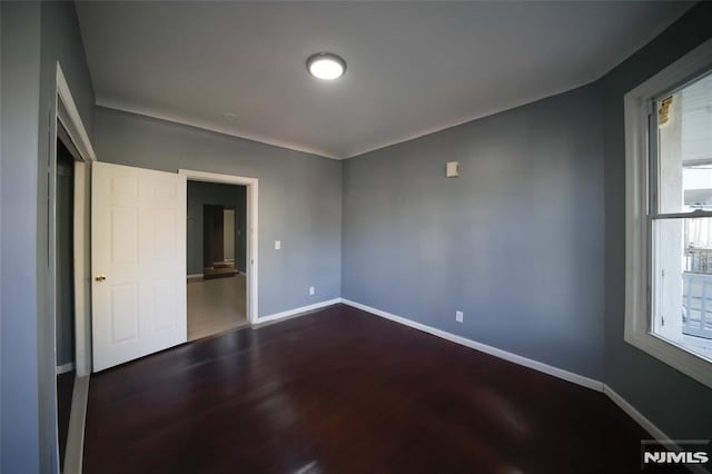 unfurnished bedroom featuring dark hardwood / wood-style flooring