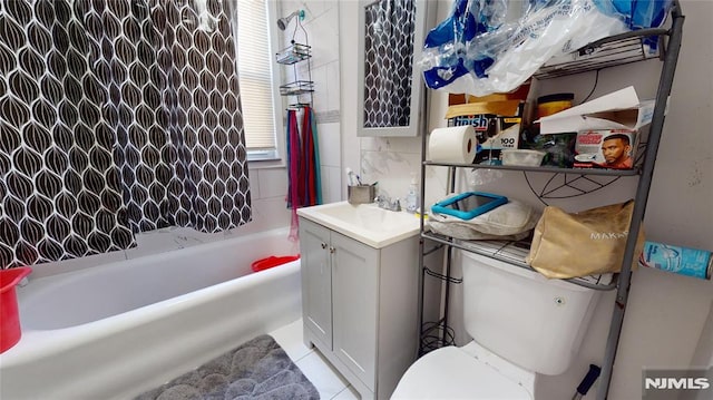 full bathroom with toilet, vanity, tasteful backsplash, tile patterned floors, and shower / bath combination