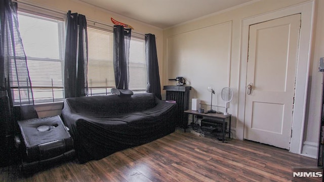 bedroom with dark hardwood / wood-style flooring and crown molding