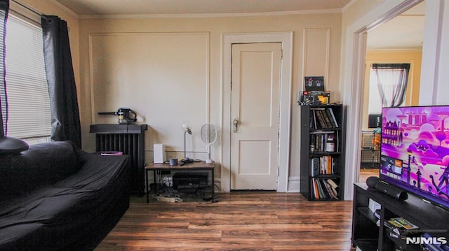 interior space with dark hardwood / wood-style flooring and ornamental molding