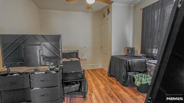 office with ceiling fan, crown molding, and hardwood / wood-style floors