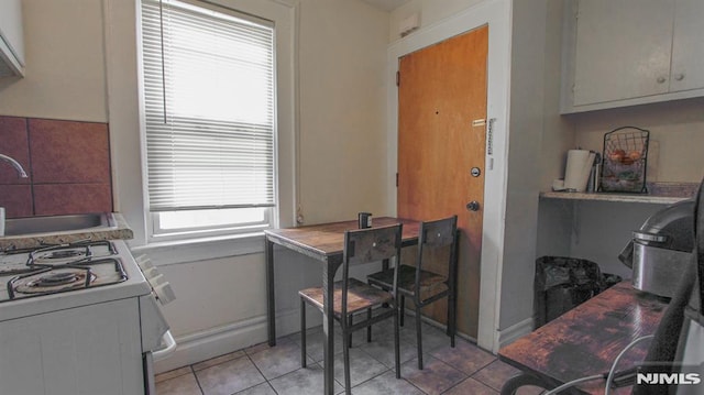 kitchen featuring sink and light tile patterned floors