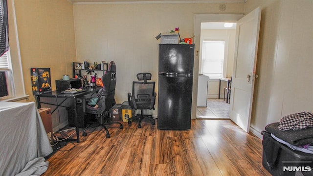 office space featuring washer / clothes dryer and wood-type flooring