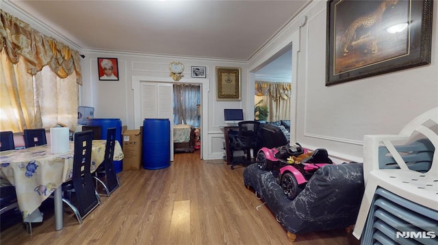 office area with crown molding and light hardwood / wood-style flooring