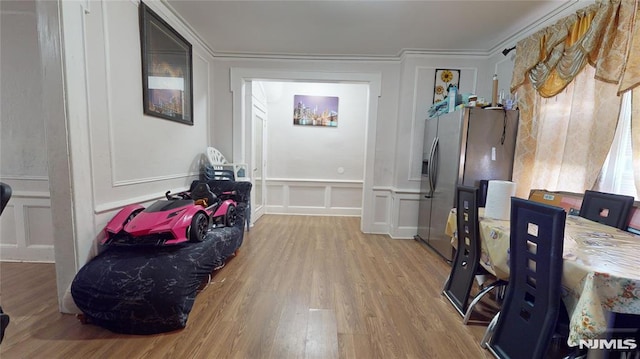 interior space with ornamental molding and wood-type flooring