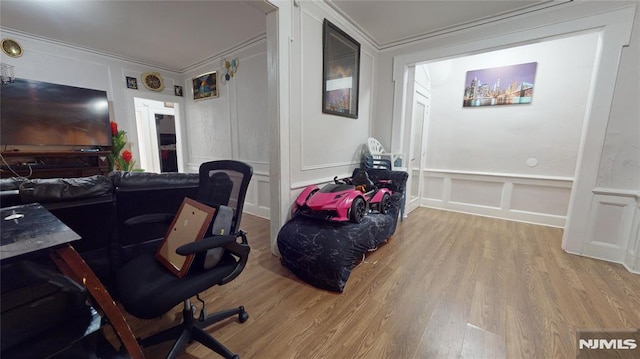 home office featuring crown molding and light wood-type flooring