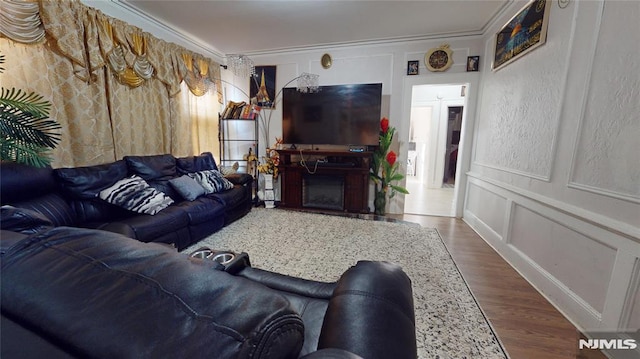 living room with ornamental molding and wood-type flooring