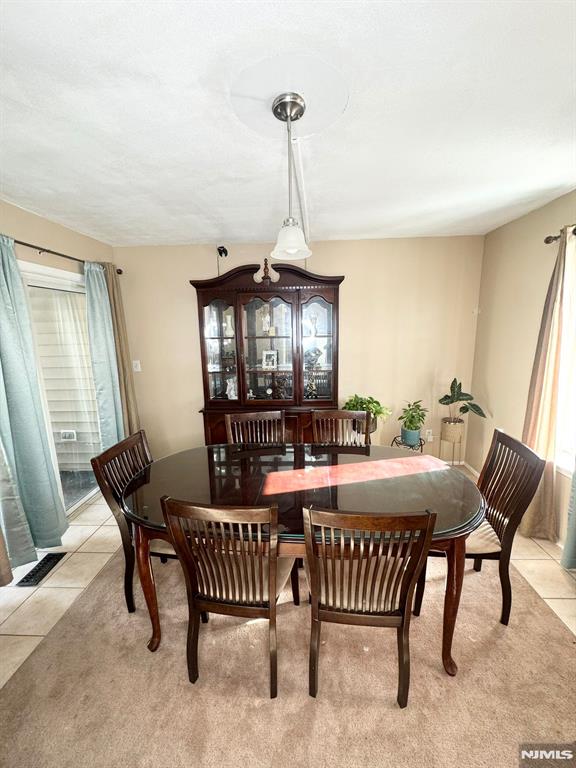 dining space with light tile patterned floors