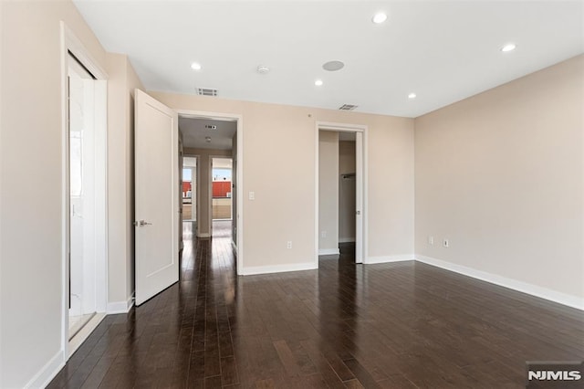 unfurnished room with dark hardwood / wood-style flooring