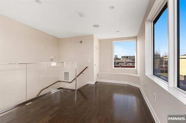 spare room featuring dark hardwood / wood-style floors