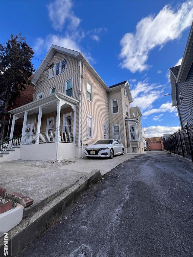 view of side of home with covered porch