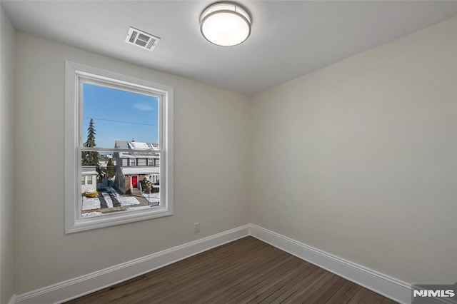 spare room featuring dark hardwood / wood-style floors