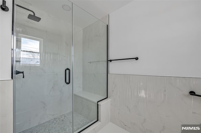 bathroom with a shower with shower door