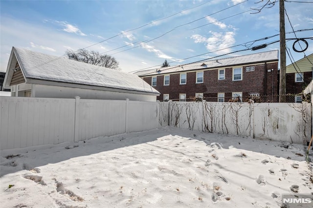 view of yard layered in snow