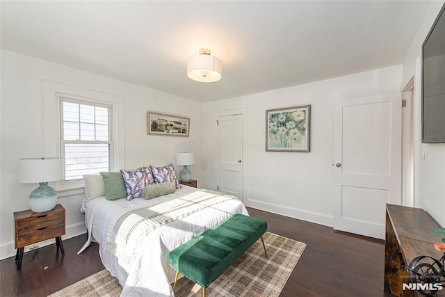 bedroom with dark wood-type flooring