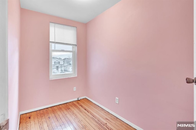 empty room with light hardwood / wood-style flooring