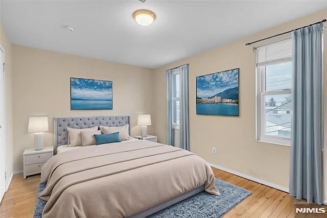 bedroom featuring light wood-type flooring and multiple windows