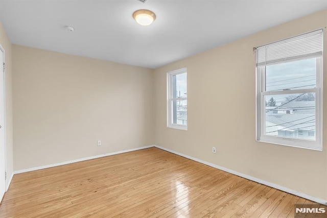 unfurnished room with light hardwood / wood-style flooring