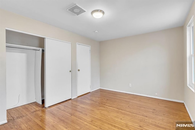 unfurnished bedroom featuring light wood-type flooring