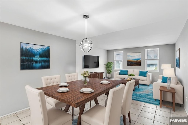 dining room with a notable chandelier and light tile patterned flooring