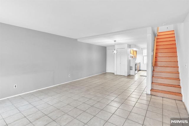 unfurnished living room with light tile patterned flooring