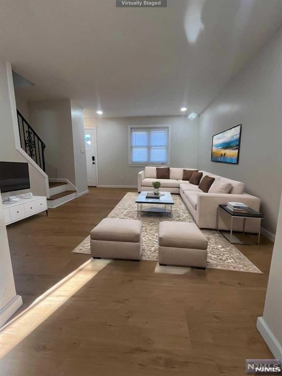 living room with dark hardwood / wood-style flooring