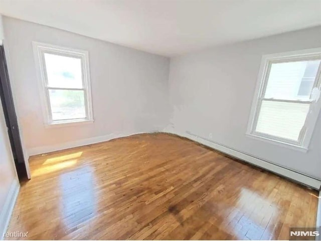 empty room with hardwood / wood-style flooring