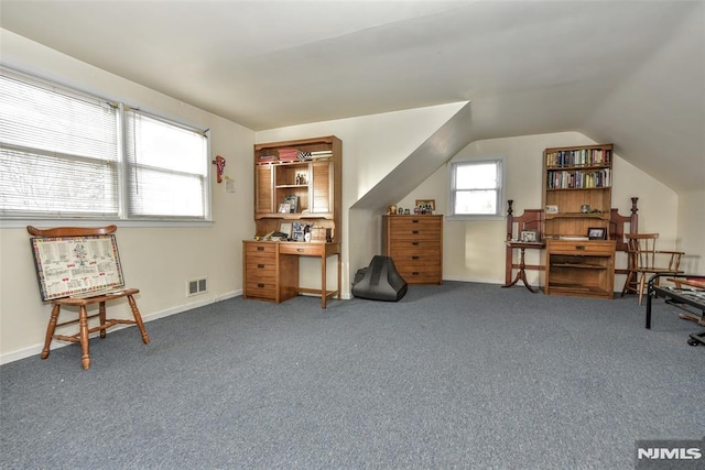 sitting room featuring carpet floors and vaulted ceiling