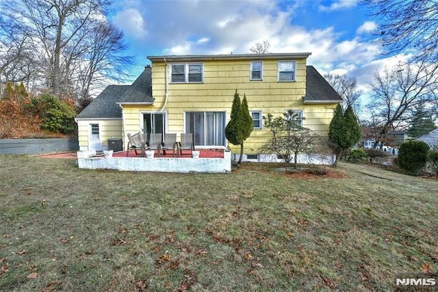 back of property with a patio area, cooling unit, and a yard