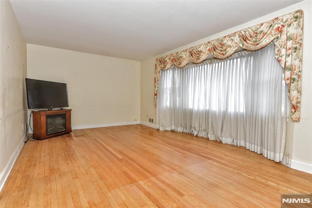 unfurnished living room with hardwood / wood-style floors