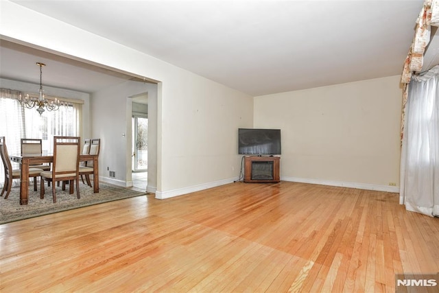 living room featuring a notable chandelier and hardwood / wood-style floors