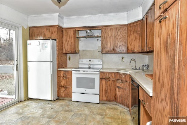 kitchen featuring sink, backsplash, and white appliances