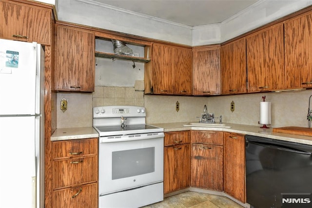 kitchen featuring sink, white appliances, and decorative backsplash