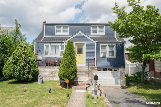 view of front of house with a garage and a front lawn