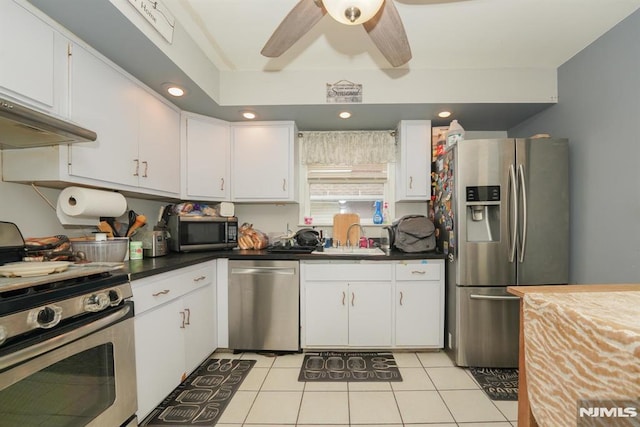 kitchen featuring white cabinets, stainless steel appliances, sink, ceiling fan, and light tile patterned floors