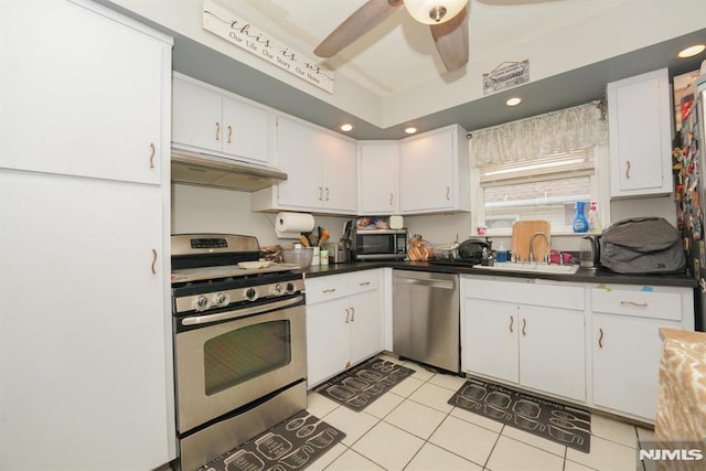 kitchen featuring sink, white cabinetry, light tile patterned floors, and stainless steel appliances