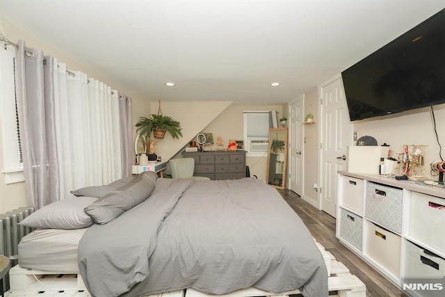 bedroom with dark hardwood / wood-style flooring