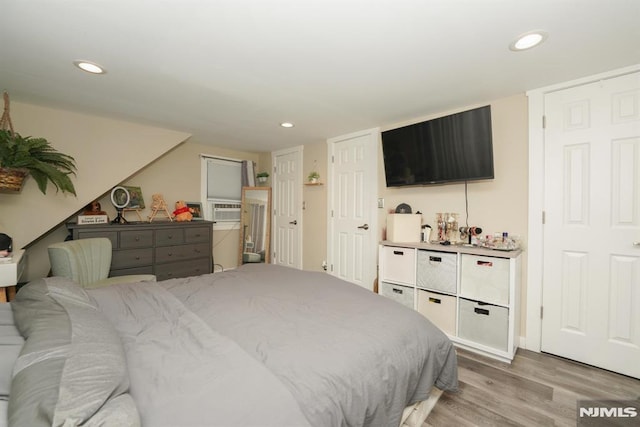 bedroom with light wood-type flooring and cooling unit