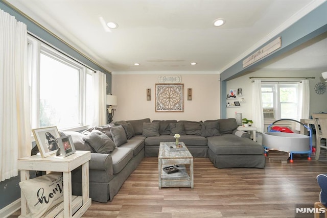 living room featuring hardwood / wood-style floors and crown molding