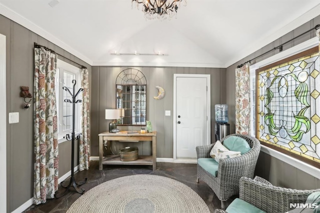 sitting room featuring a notable chandelier, vaulted ceiling, and crown molding