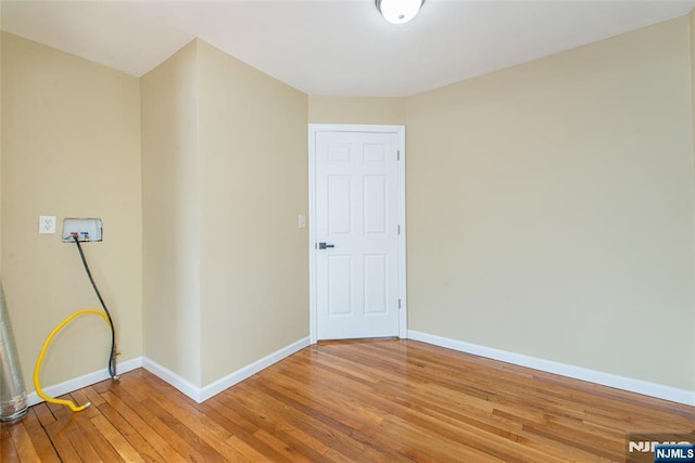 empty room with hardwood / wood-style flooring