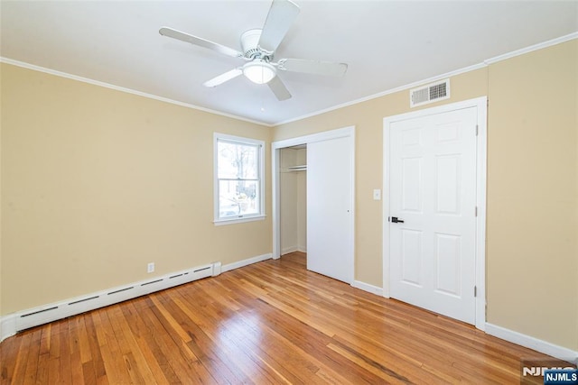 unfurnished bedroom with ornamental molding, ceiling fan, light hardwood / wood-style flooring, and baseboard heating