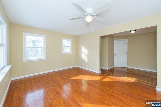 empty room with hardwood / wood-style flooring and ceiling fan