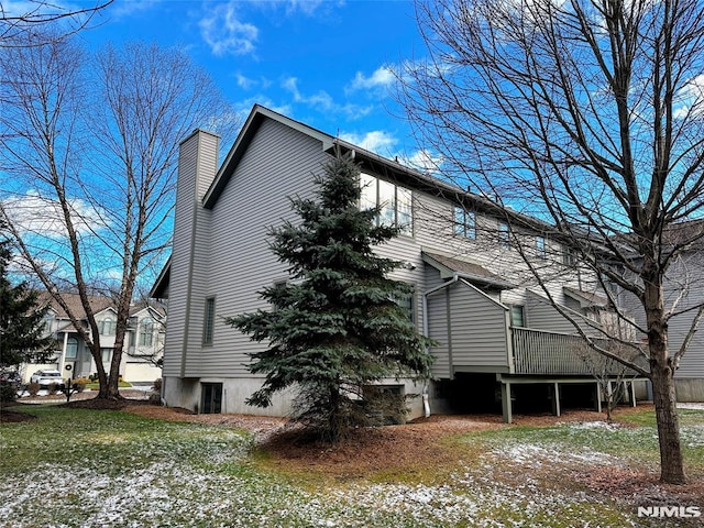 view of side of property with a deck