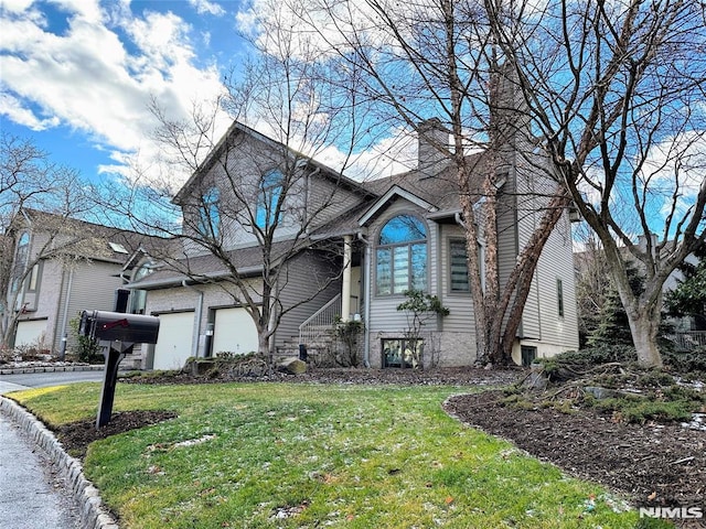 view of front of property with a garage and a front yard