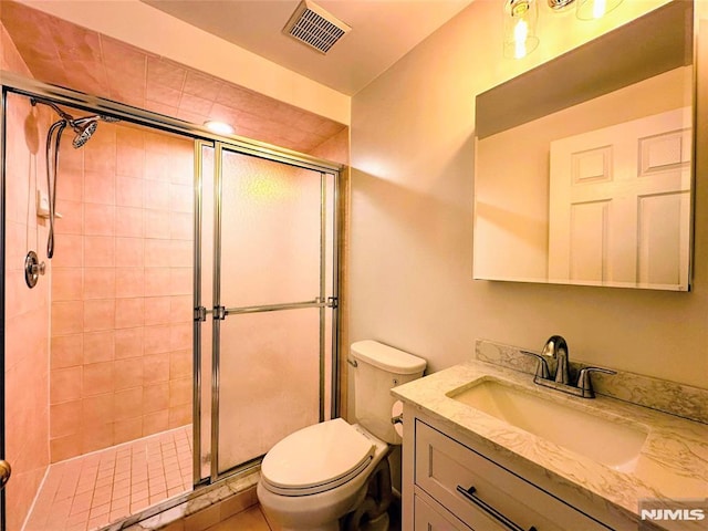 bathroom with walk in shower, vanity, and toilet