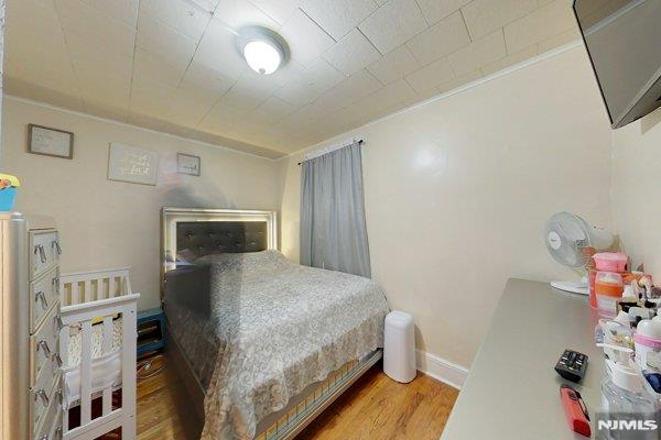 bedroom with wood-type flooring