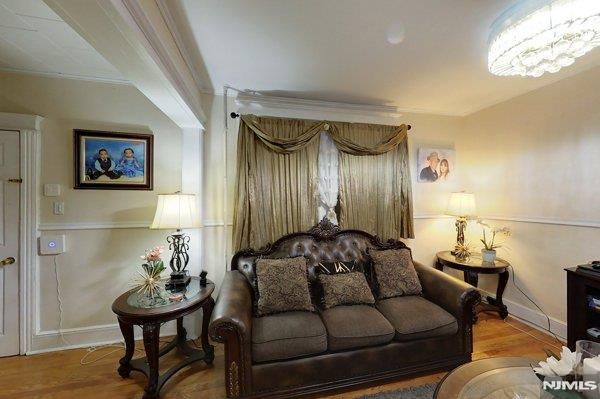 living room featuring ornamental molding and hardwood / wood-style floors